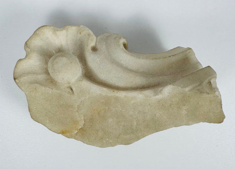 Detail view of a carved marble architectural fragment from a historic church interior in Sicily.