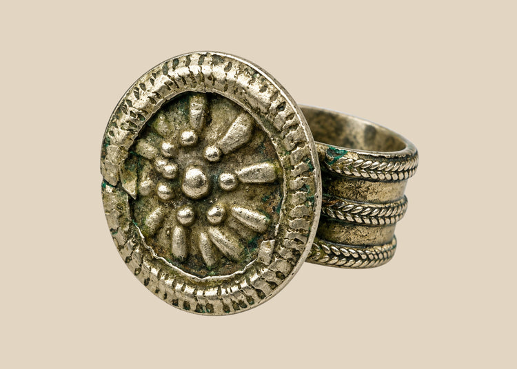 Late 19th century European silver-toned ring with raised rosette floral motif, beaded border, and tapered band, antique Victorian-era jewelry piece