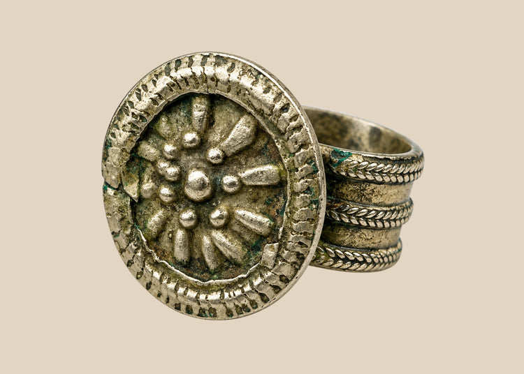 Late 19th century European silver-toned ring with raised rosette floral motif, beaded border, and tapered band, antique Victorian-era jewelry piece
