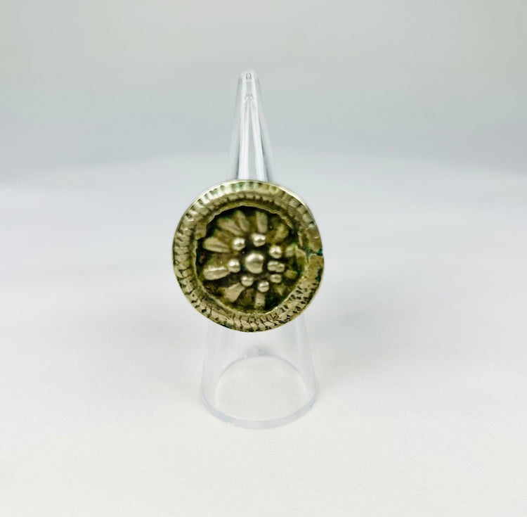 Antique Victorian-era ring featuring a floral rosette design and beaded border.