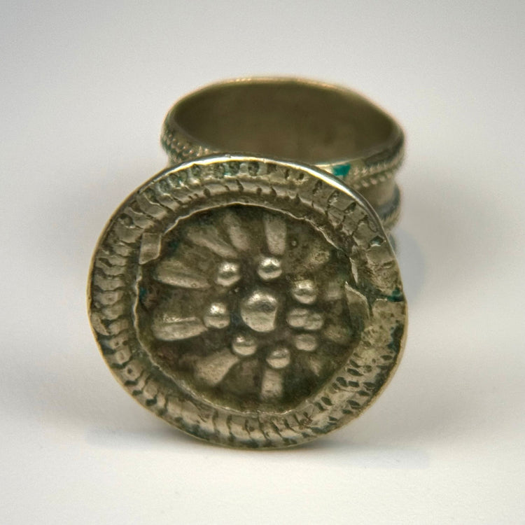 Historic European ring with raised rosette decoration, beaded edging, and preserved late 19th-century design