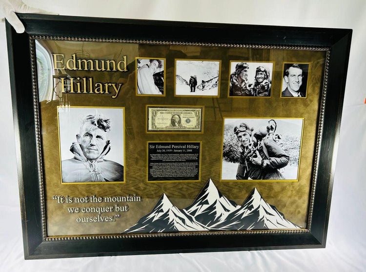 Framed display featuring Sir Edmund Hillary’s authentic signature on a U.S. $1 banknote, professionally mounted with archival matting and glass. Includes vintage photographs from the 1953 Mount Everest expedition and the quote “It is not the mountain we conquer but ourselves.” Certified and museum-quality presentation honoring Hillary’s historic climb.