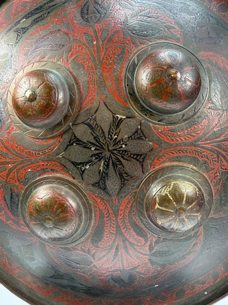 Indo-Persian Dhal shield in lacquered steel with red and black decoration and damascened foliate motifs