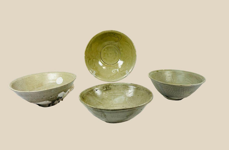 Set of four Song Dynasty celadon-glazed terracotta bowls, 12th Century CE, recovered from the Jepara Shipwreck off Central Java. Each bowl features transparent celadon glaze, incised floral interiors, linear exterior decoration, and unglazed foot rings. Marine barnacle and mussel accretions attest to maritime provenance, reflecting Song-era craftsmanship and trade across Southeast Asia.
