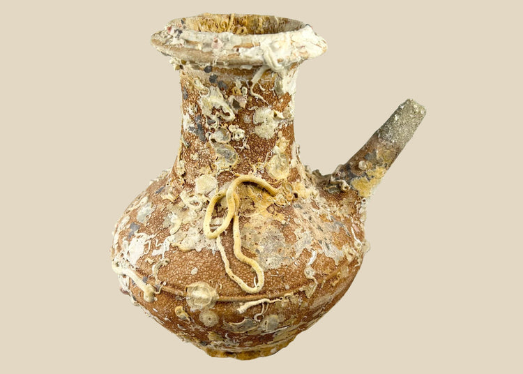 Song Dynasty terracotta wine pot recovered from Balabac Island, Philippines, heavily encrusted with marine deposits, featuring wide rounded body and slender spout, maritime shipwreck artifact
