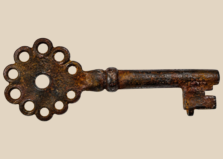 Spanish colonial iron key with pierced bow and eight circular cutouts
