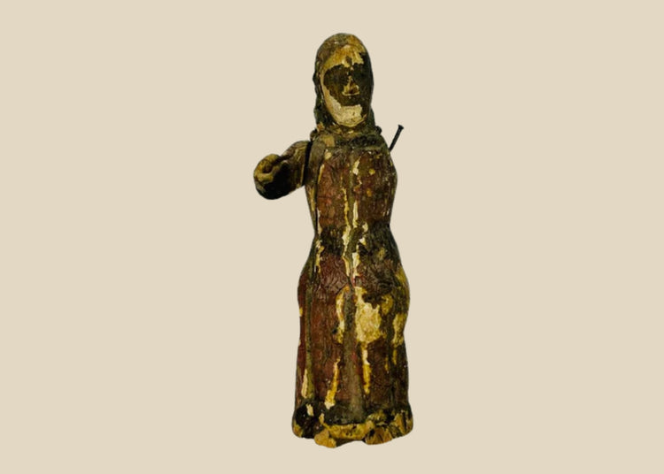 17th-century Spanish Colonial carved wooden figure of a saint with remnants of polychrome paint, expressive facial features, missing one arm, showing age and devotional use.