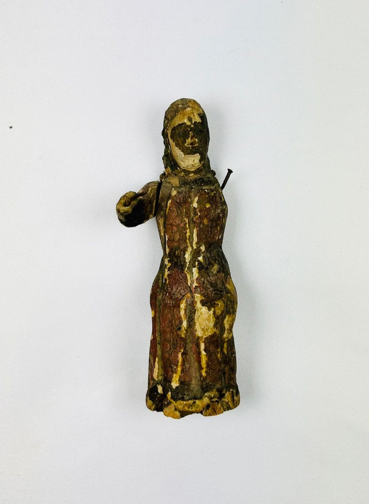 17th-century Spanish Colonial carved wooden figure of a saint with remnants of polychrome paint, expressive facial features, missing one arm, showing age and devotional use.