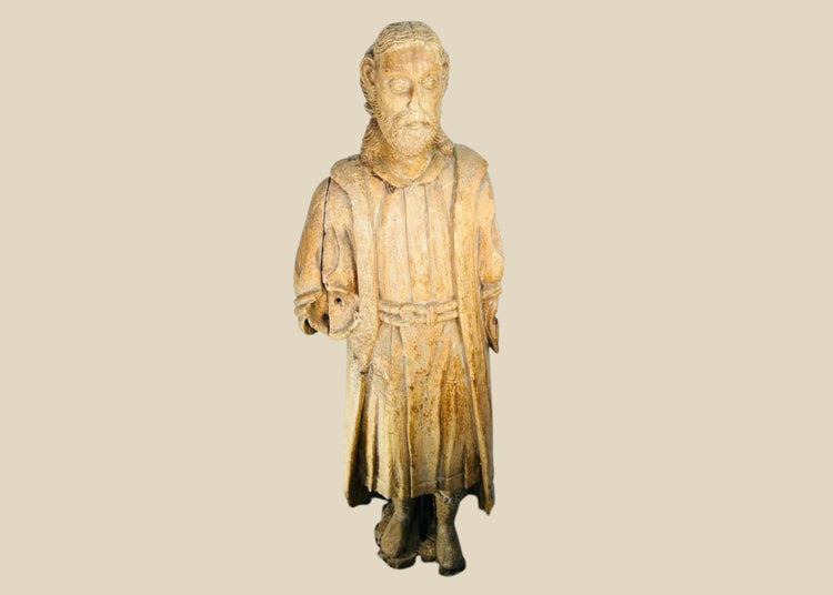Antique Spanish Colonial wooden Santo statue depicting a standing saint with detailed robes and facial features, mounted on a black display base, 18th–19th century.