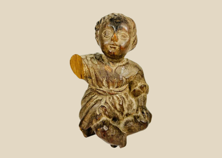 18th–19th century Spanish Colonial wooden figurine of the Christ Child or child saint. Hand-carved folk art style with expressive face, draped clothing, traces of original polychrome, and natural patina. Devotional object reflecting Colonial Latin American religious traditions and daily spiritual practice.