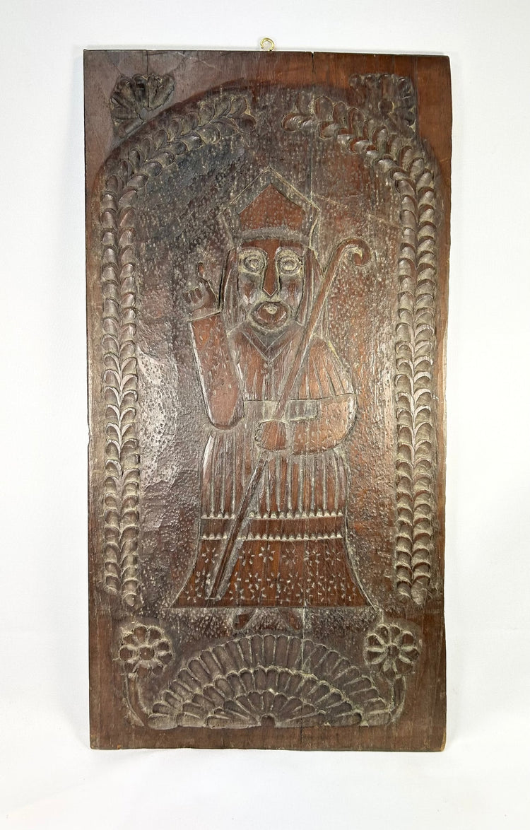 Hand-carved wooden devotional panel of a mitered bishop saint with foliate border, Central Europe, c.1780–1830