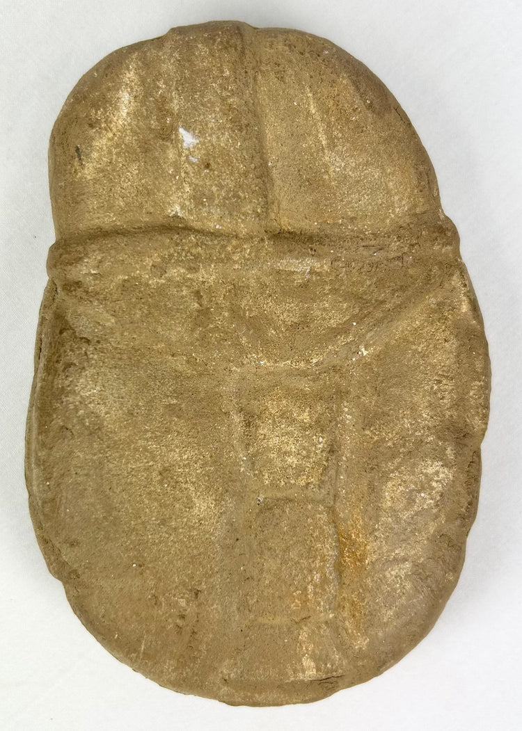 Boldly carved stone face effigy with warrior symbolism and patina