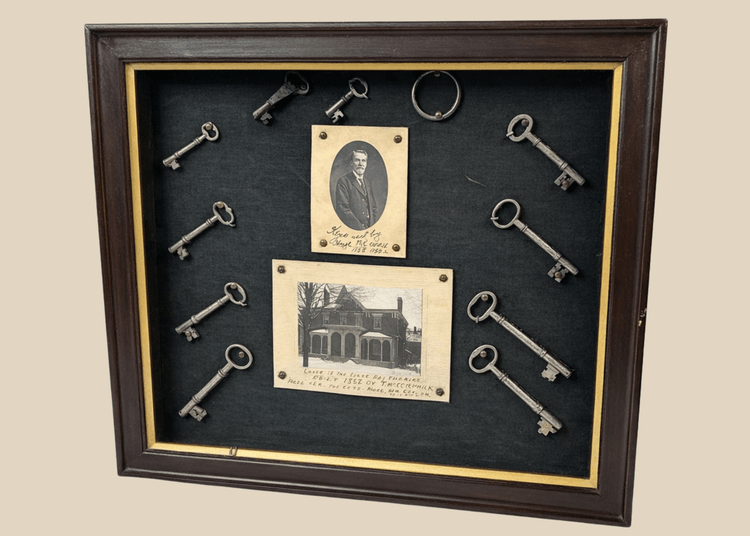 Framed 19th-century display with eleven iron keys, portrait of night watchman Hugh Newell, and early photograph of T. McCormick’s 1867 factory, preserved in a wooden shadowbox.