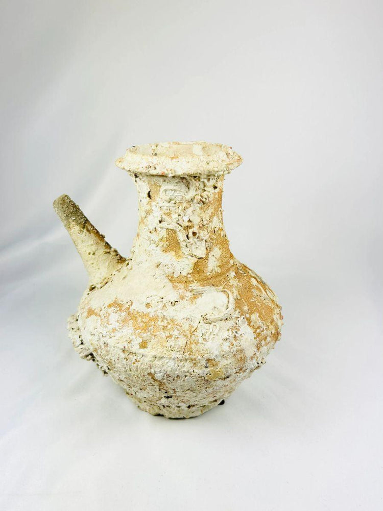 Song Dynasty Chinese terracotta wine pot with marine encrustations, recovered from a shipwreck near Balabac Island, featuring a wide mouth, rounded body, and slender spout, reflecting ancient maritime trade and centuries underwater.