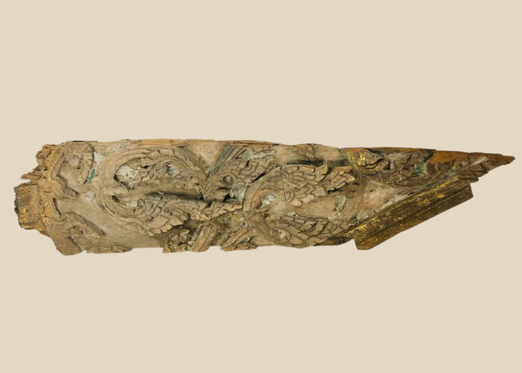17th-century Thai Ayutthaya carved wooden temple fragment with flowing motifs, remnants of gilding, and symmetrical sacred design.