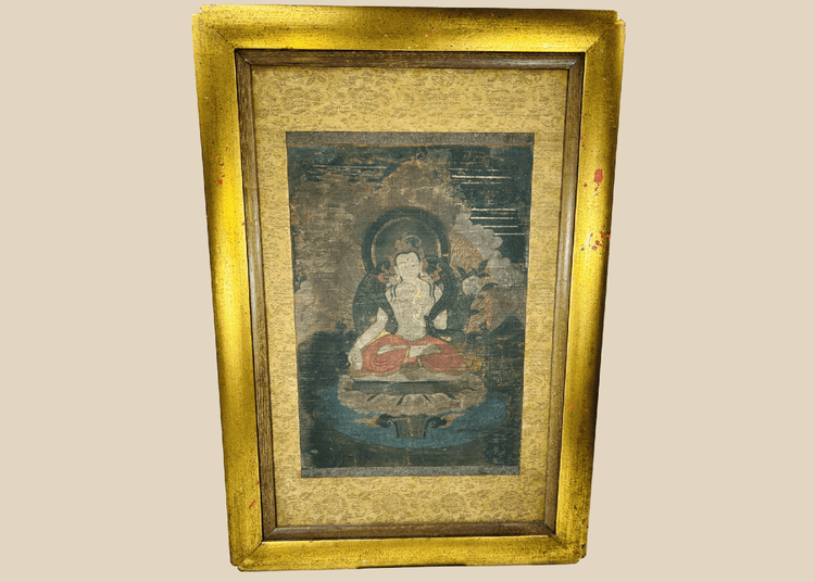Tibetan Buddhist silk painting of seated figure with halo in ornate frame