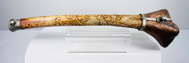 Detailed Tibetan Buddhist kangling showing carved dragon ornamentation, natural bone patina and metal fittings