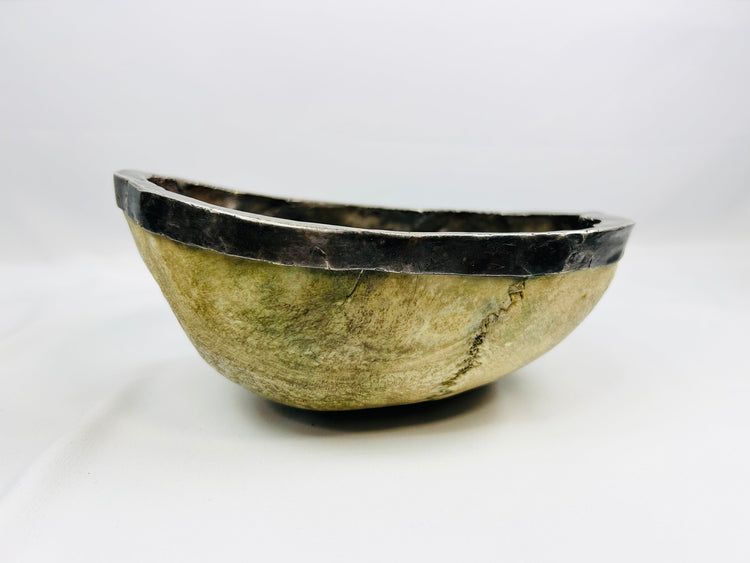 19th-century Tibetan Kapala ritual skull cup showing human bone bowl with silver rim, used in Tantric Buddhist ceremonies.
