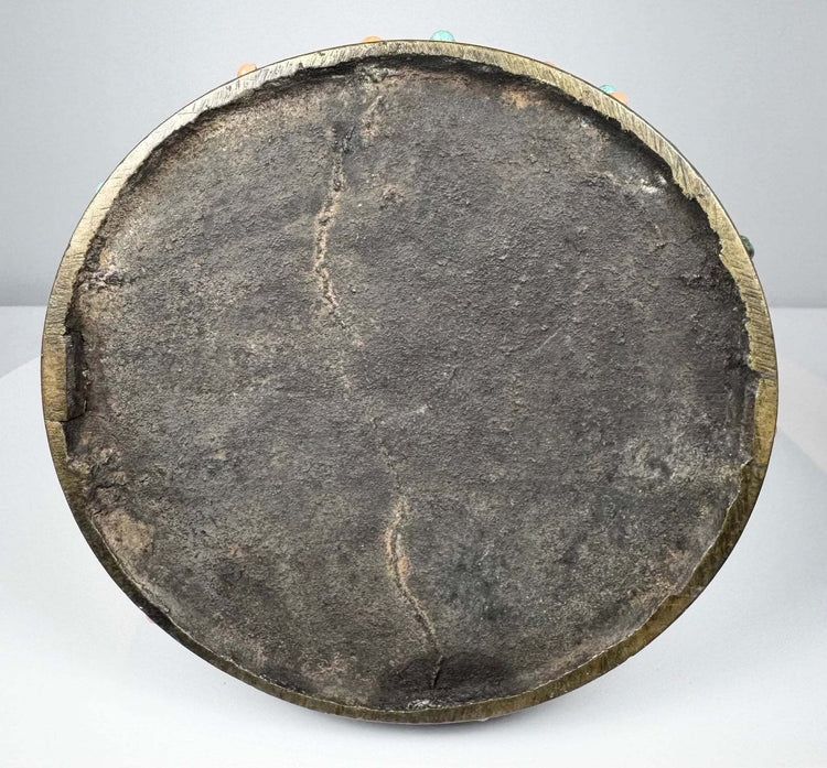 Close-up of antique bronze stirrup footplate showing textured patina and casting details