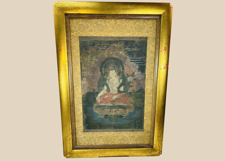 Tibetan Buddhist silk painting of seated figure with halo in ornate frame