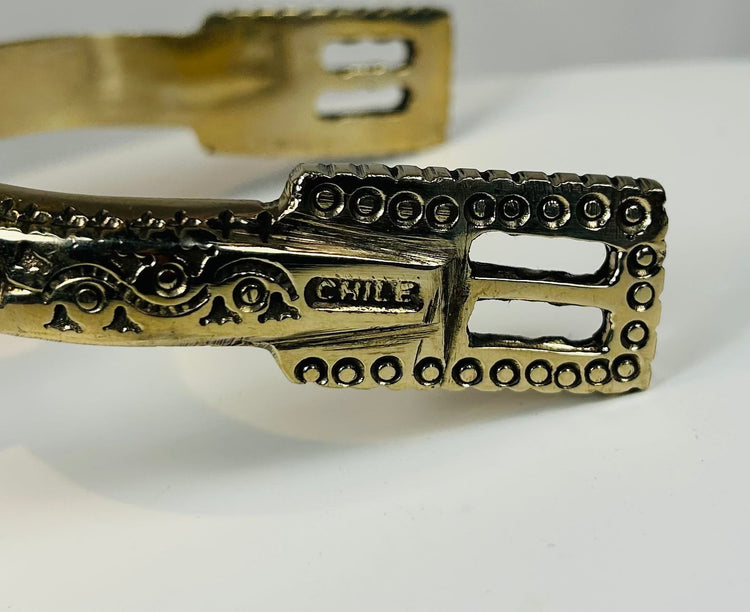 Decorative huaso spurs with pierced heel bands and engraved shanks