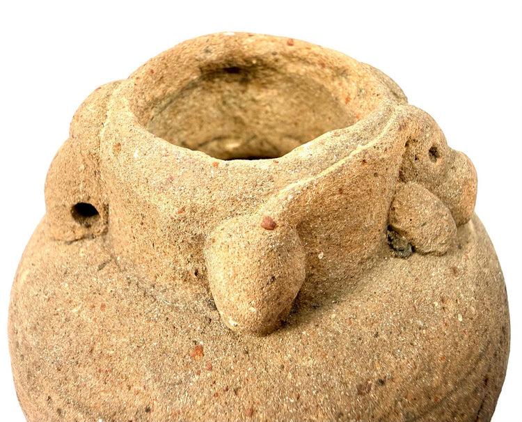 Detail of terracotta vessel rim showing granular clay texture and handle attachment