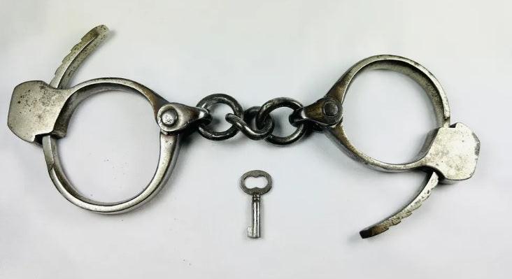 Antique Tower Detective handcuffs with original key, U.S., early 20th century
