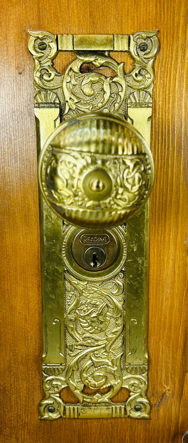 Antique Reading Hardware Company lockset mounted on wooden demonstration board