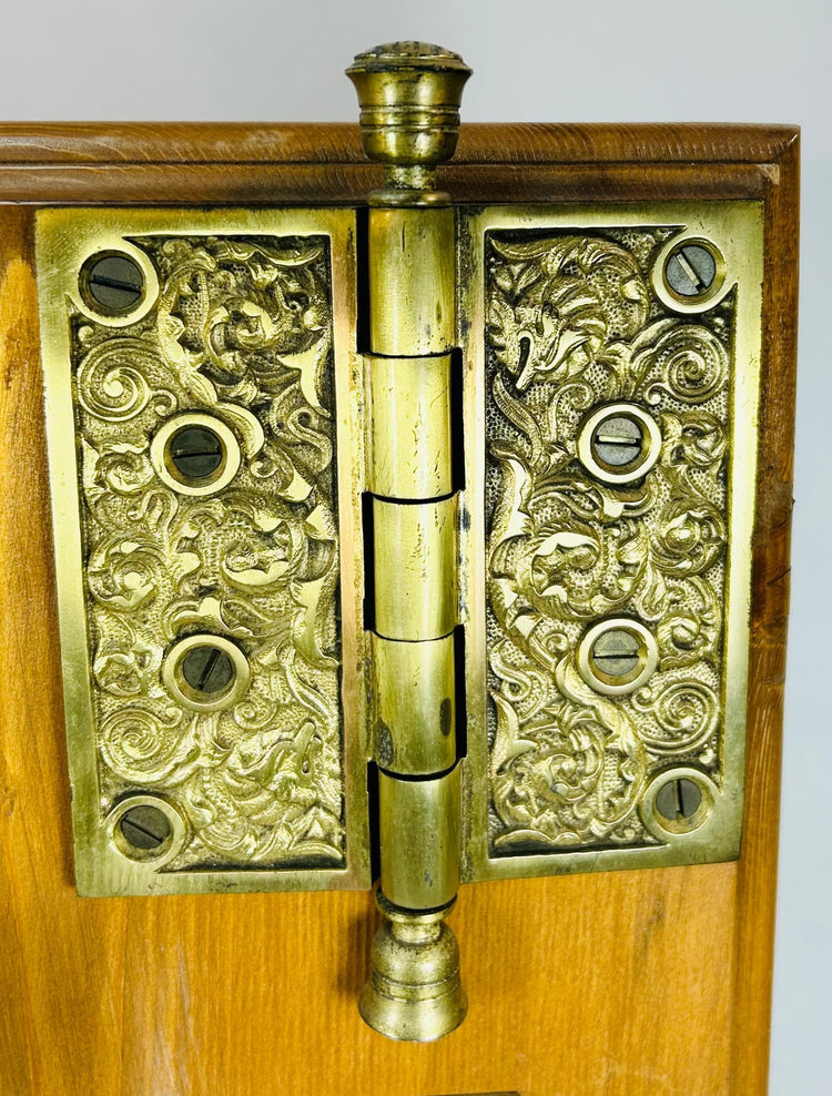 Victorian era brass door hardware with decorative escutcheon and hinge