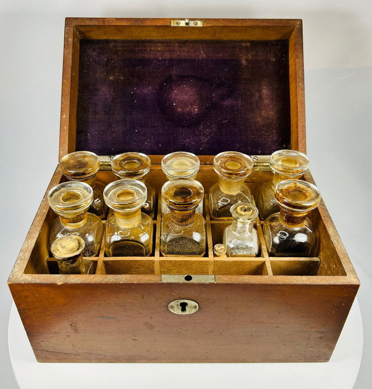 vintage mahogany pharmaceutical case with labeled medicine containers