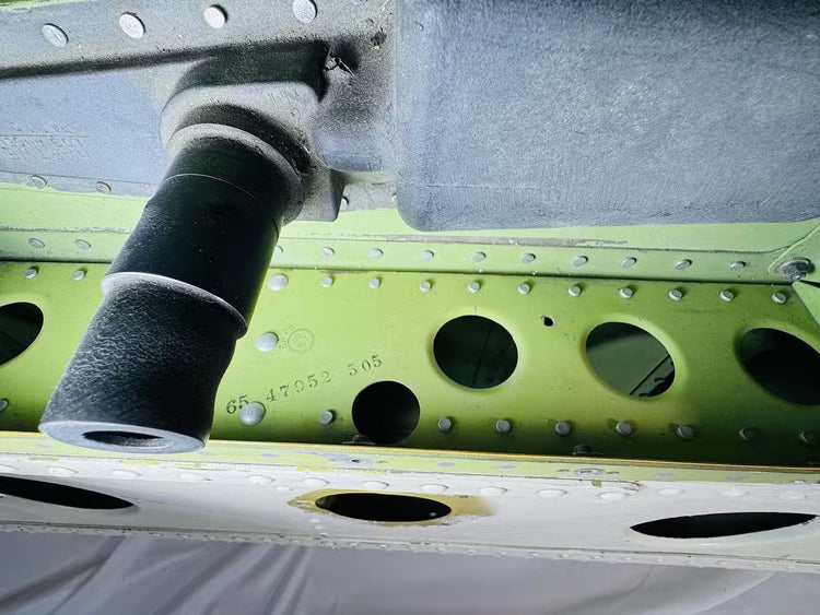 Close-up of the Boeing aircraft cargo door latch mechanism and surrounding aluminum riveted panel
