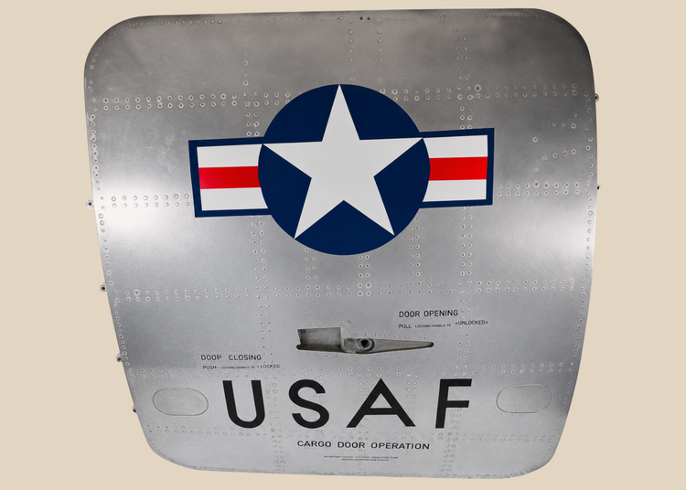 Full front view of a Boeing 737 USAF aft cargo door with Star and Bars insignia and polished aluminum skin