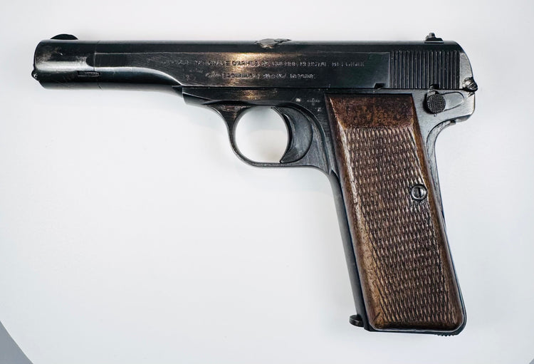 FN Browning Model 1922 showing slide serrations, a manual safety lever, and age-related wear along the steel frame.