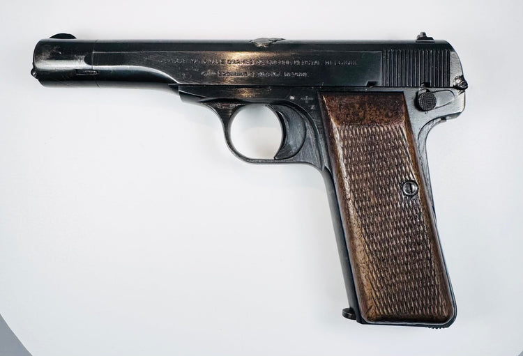 FN Browning Model 1922 showing slide serrations, a manual safety lever, and age-related wear along the steel frame.