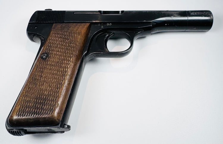 FN Browning Model 1922 with a long steel slide, checkered walnut grip, and a single slotted grip screw.