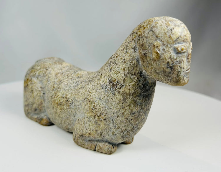 Hand carved tribal stone figure with abstract animal representation