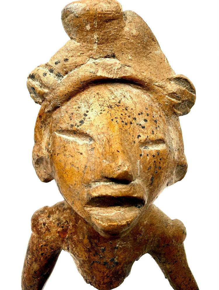 Detail shot of ancient West Mexican terracotta head with deeply incised eyes