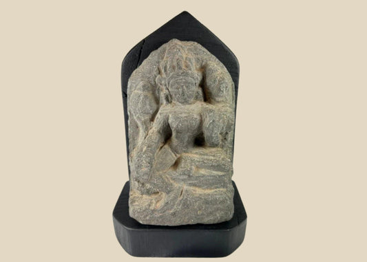 14th-century carved stone stele from West Tibet depicting the Buddhist deity Tara, “Mother of Liberation,” mounted on a black base, showing detailed facial features and traditional iconography, 6 inches tall.