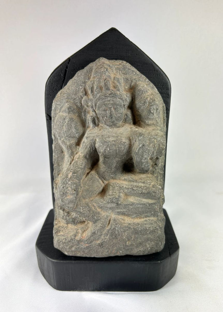 14th-century carved stone stele from West Tibet depicting the Buddhist deity Tara, “Mother of Liberation,” mounted on a black base, showing detailed facial features and traditional iconography, 6 inches tall.