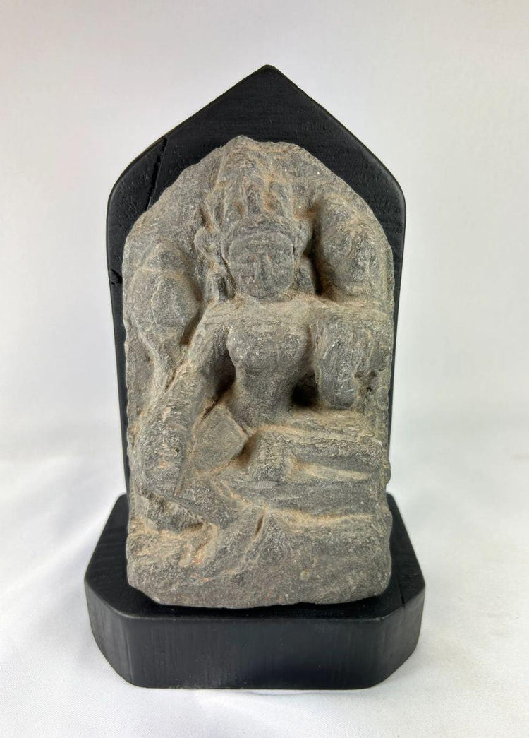 14th-century carved stone stele from West Tibet depicting the Buddhist deity Tara, “Mother of Liberation,” mounted on a black base, showing detailed facial features and traditional iconography, 6 inches tall.