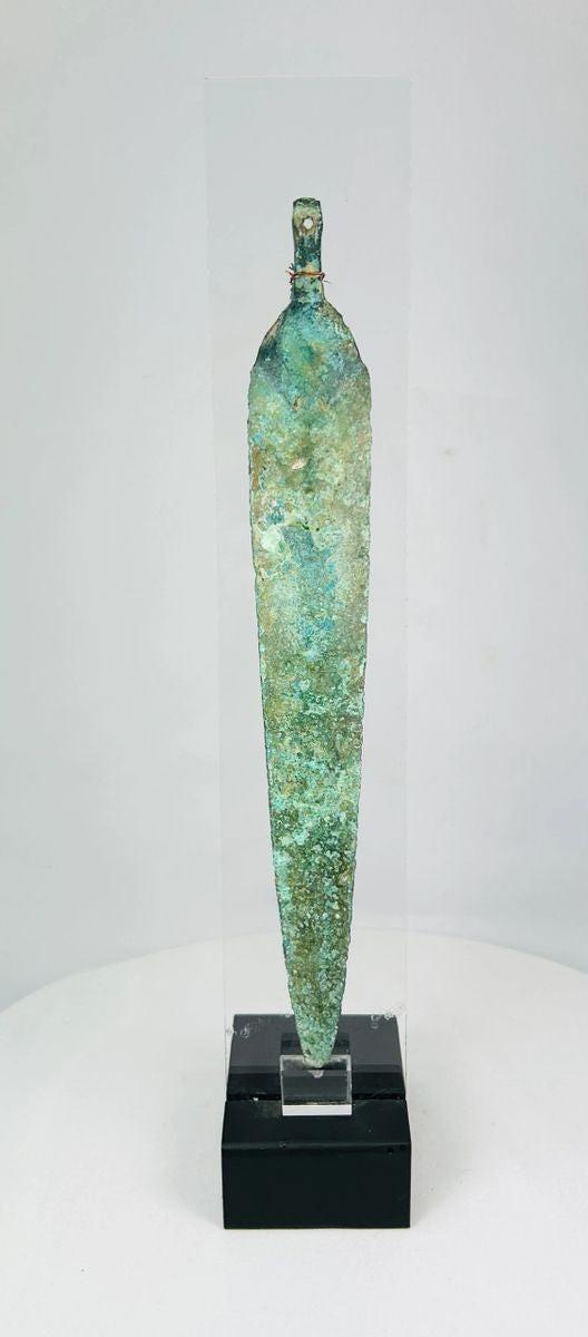 Close-up showing corrosion patterns and surface texture on a Near Eastern bronze blade