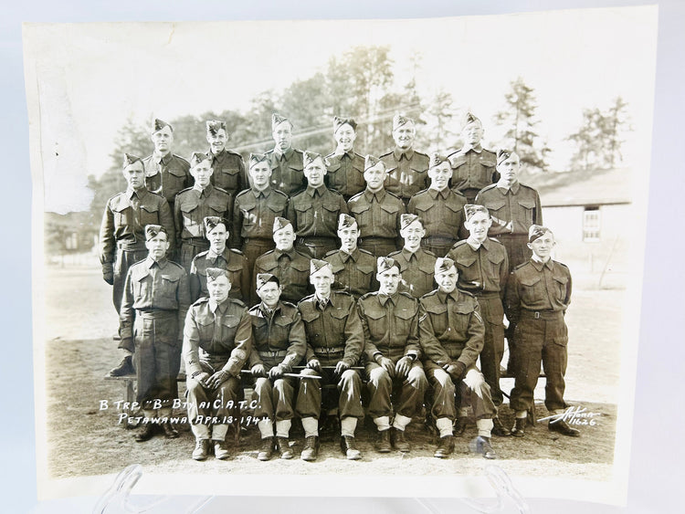 Vintage World War I soldier memorabilia: compass, spent shell, and sepia photograph of troops