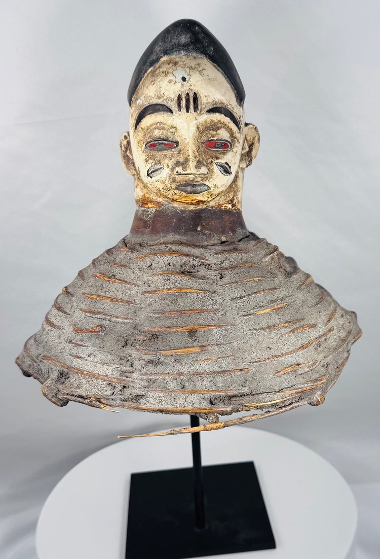 African Yoruba ancestor masquerade headdress displaying carved wood construction and surviving wicker costume framework.