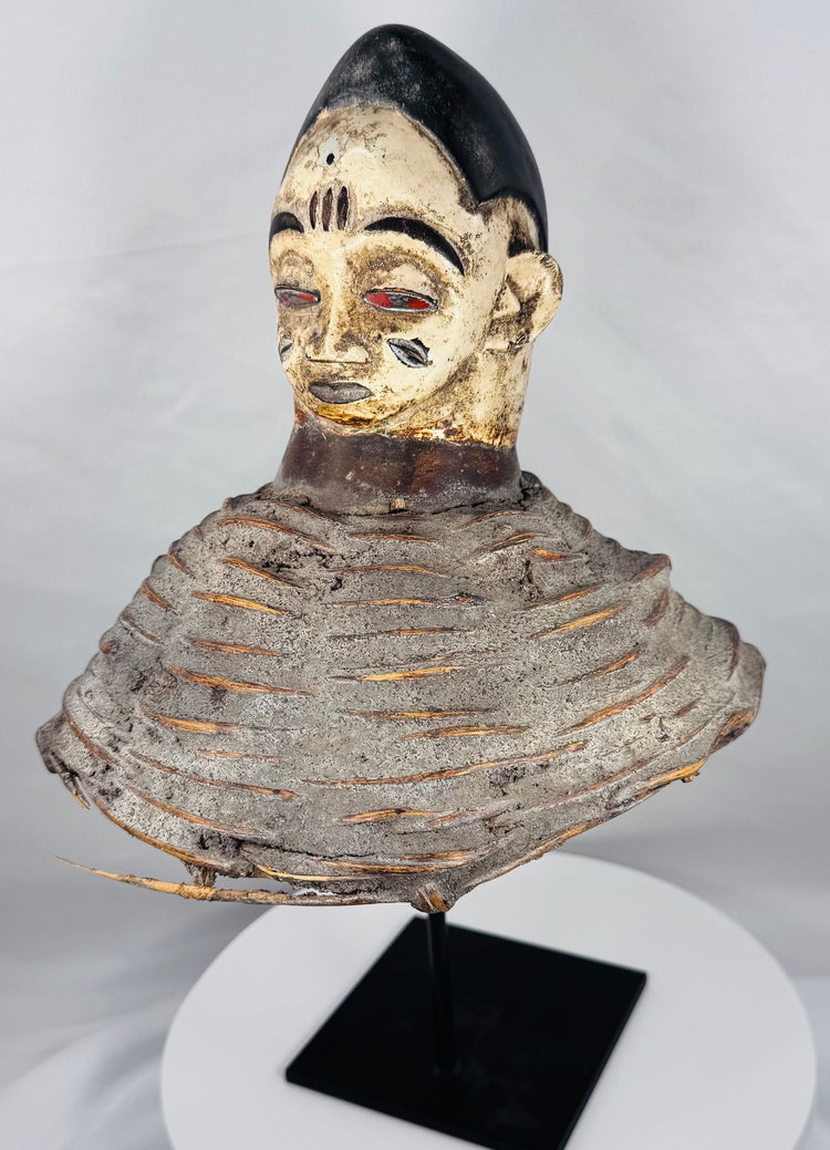 Traditional Yoruba Egungun headpiece from Nigeria with scarification details, black coiffure, and aged painted finish.