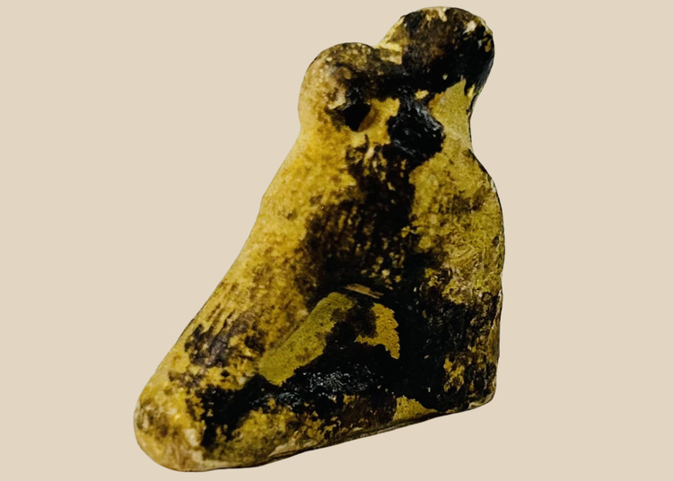 Ancient Egyptian carved stone falcon amulet associated with the god Horus from the Late Period.