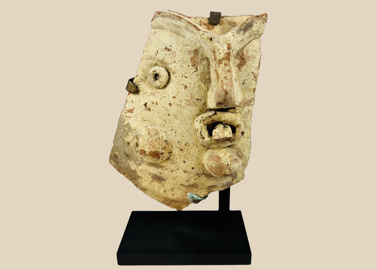Ancient Greco-Roman terracotta theatrical mask fragment mounted on display stand, Hellenistic to Roman period.