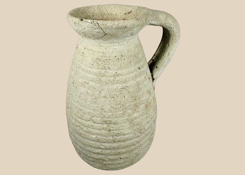 Ancient Roman North African terracotta pitcher from modern Tunisia with ribbed body and loop handle.