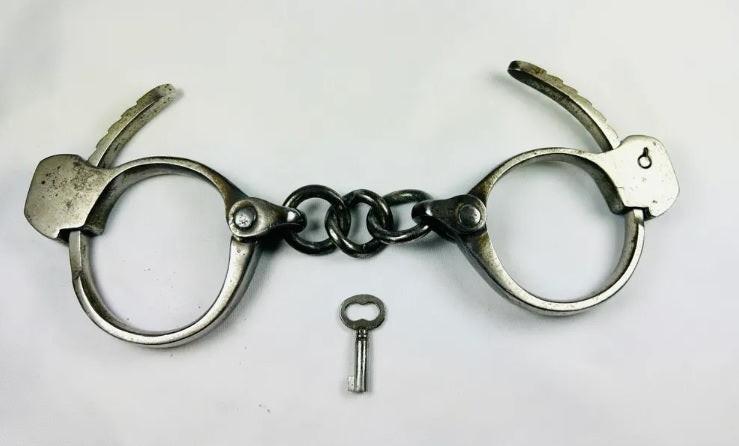 Vintage Tower Detective-style handcuffs with key, United States, early 1900s