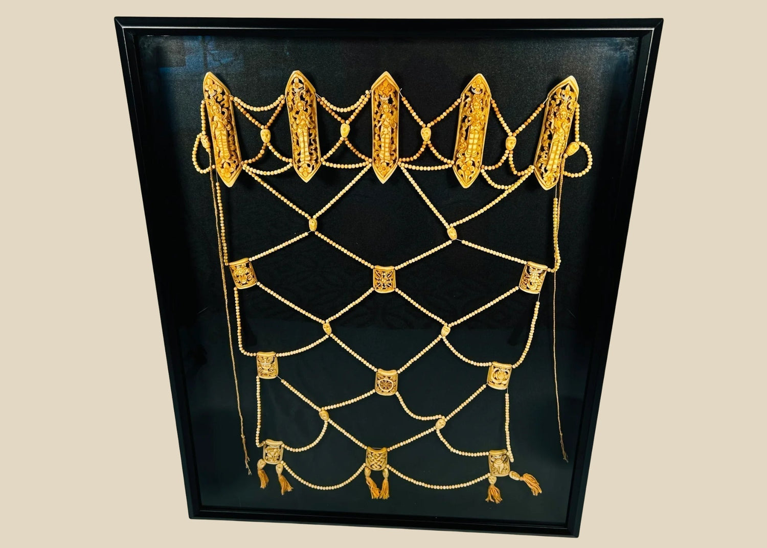 19th-century Tibetan bone apron displayed in a frame, traditional tantric ritual ornament.