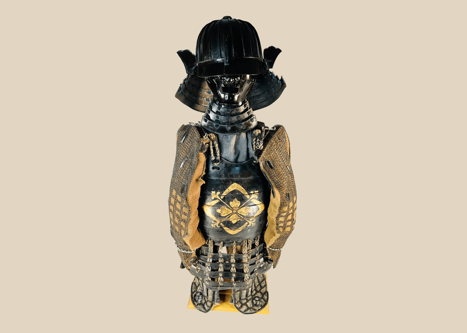 Antique Japanese samurai armor figure with kabuto helmet and ornate chest plating.